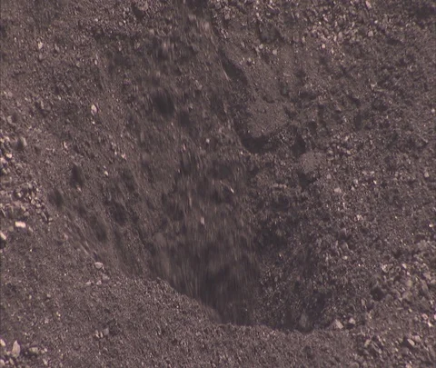 CU coal sink hole, then hole fills in. Stock Footage 86694229