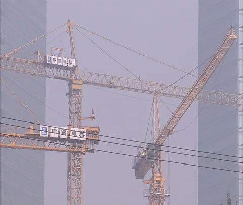 CU of construction cranes high above Stock Footage 86744093