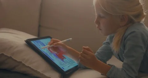 CU Cute Caucasian 5 y.o. girl coloring an image on digital tablet using stylus Stock Footage 79919575