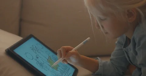 CU Cute Caucasian 5 y.o. girl coloring an image on digital tablet using stylus Stock Footage 79919584