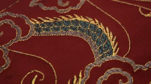 CU DS Embroidered silk dragon on red cloth Stock Footage 69952948