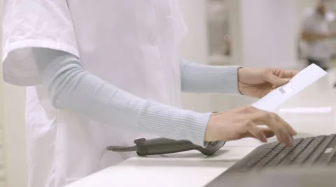 CU Female pharmacist scanning through bar code scanner in pharmacy Stock Footage 31956379