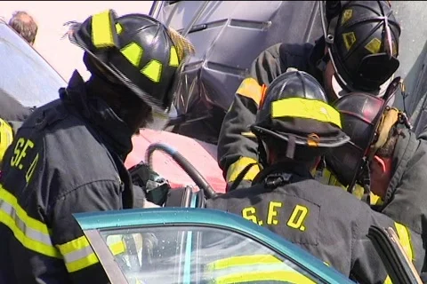 CU Firemen Work to Release Victim from Car Accident 動画素材 852167