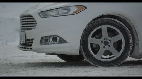 CU front of car and tire on snowy day Stock Footage 56980609
