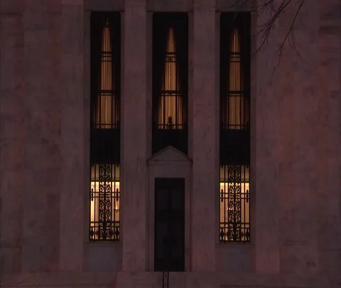CU front of Federal Reserve Building with bus passing in foreground at night. Stock Footage 86749935