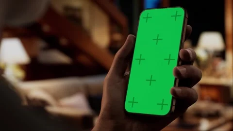 CU Green screen chroma key, Black African-American male using his phone at home Stock Footage 253789596