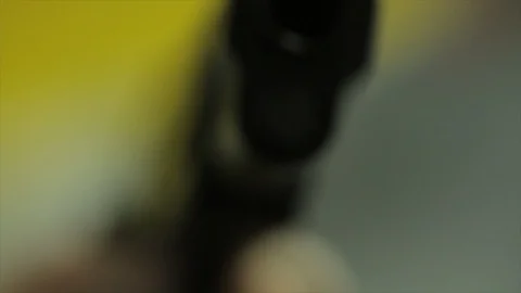CU of a Gun Held by an Unseen Man HD Video Stock Footage