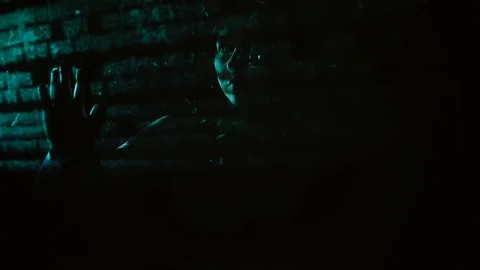 CU: Hacker girl is in the dark behind the transparent screen and is studying the 스톡 동영상 105120210