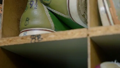 CU Handheld of Old Bowling Shoes in cubbyholes Vídeos de archivo 87649857