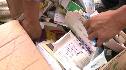 CU hands sorting waste paper and cardboard Stock Footage 37695713