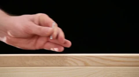 CU, Lockdown, man trying to hammer in a nail, but missing, focus on hands Stock Footage 10703325