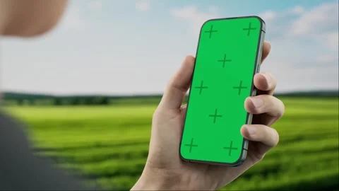 CU Male farmer checking his phone near corn field, blank screen phone mockup Stock Footage 253822772