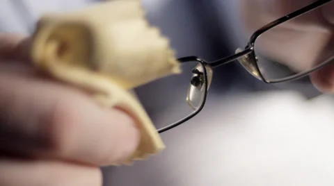 CU man cleaning glasses Stock Footage 33896463