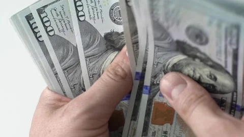 CU Man counts wad of 100 american dollars money. Cash banknotes. Bribe and Stock Footage 142379284