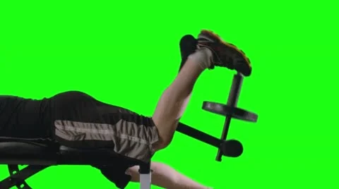 CU Man Doing Leg Curls on Exercise Bench with Green Background 4K Stock Footage 57988773
