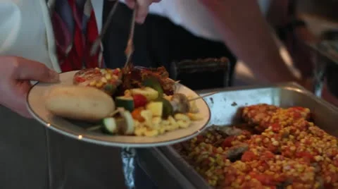 CU Man Loading Plate from Buffet Chiken Stock Footage 11849393