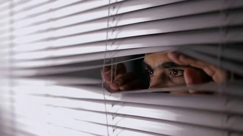 CU Man opening blinds and looking out Stock Footage 69937500