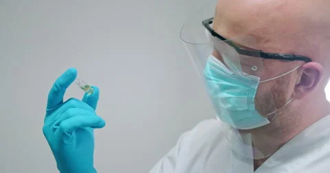 CU Masked scientist holding vial Stock Footage 145190814