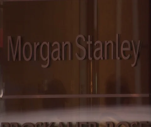 CU Morgan Stanley lettering on glass, with revolving door in reflection Stock Footage 86749093