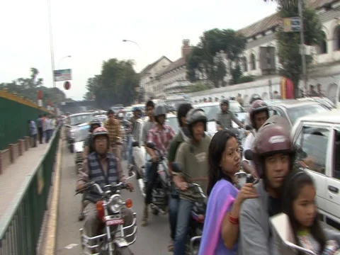 CU motorcycle and automobile traffic passing slowly Stock Footage 86748758