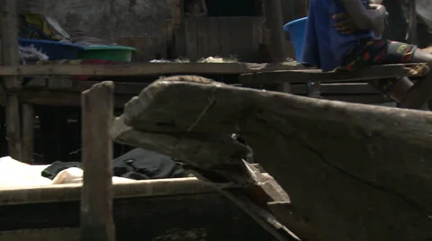 CU passing canoes, Makoko floating slum Stock Footage 38385720