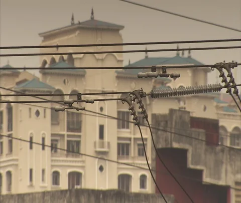 CU power lines in front of apartment building Stock Footage 86741641