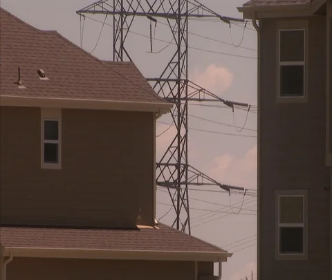 CU power lines seen between two houses Stock Footage 86691540