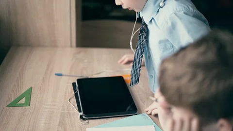 CU: Schoolboys, little boys, do their homework Stock Footage 105100548