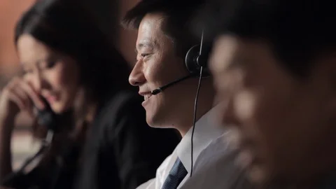 CU SELECTIVE FOCUS Customer service representatives talking in office, focus on Stock Footage 69935137