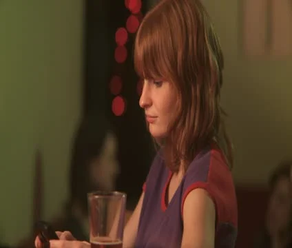 CU, Selective Focus, Young woman text messaging, man approaching her in bar Video stock 10701804