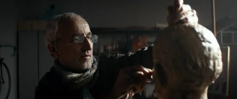 CU Senior middle eastern male sculptor working on a bust project in his workshop Stock Footage 146055087