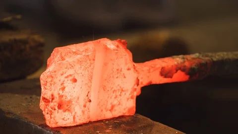 CU showing the Master Swordsmith indicating a hammer strike for the apprentice.  스톡 동영상 125431375