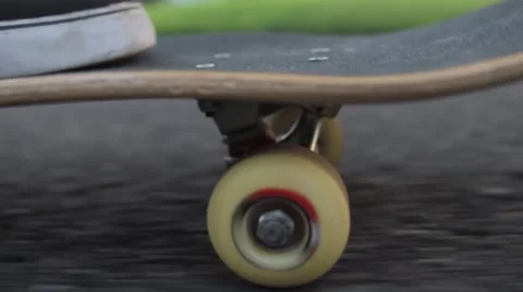 CU of Skateboard rolling down street Stock Footage 56362571