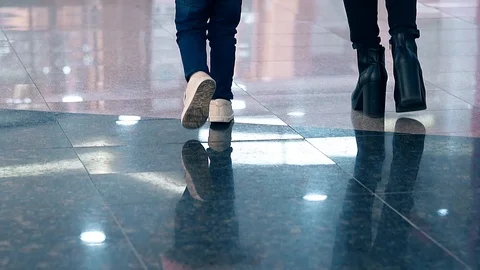 CU, Slow motion: Young mother leads little child by the hand, they walk along Stock Footage 105121838