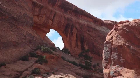 CU small arch at Arches National Park, blue sky, white clouds Stock Footage 41750638