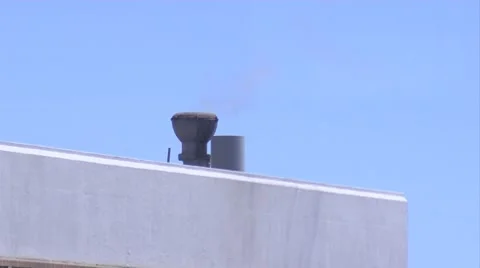 CU, smog exiting through vent on roof, plane fly by in background Stock Footage 8537525