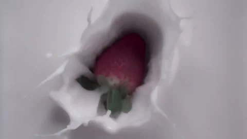 CU, Top down: Super slow mo - strawberry dropping into milk. UHD25p Stock Footage 249604341