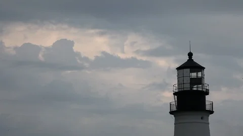CU Top of Lighthouse with Spinning Light, Clouds in Background, Pan Reveal Stock Footage 127254327
