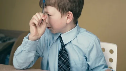 CU, Tracking: schoolboy does homework, writes a pen in a notebook, uses a Video stock 105097724