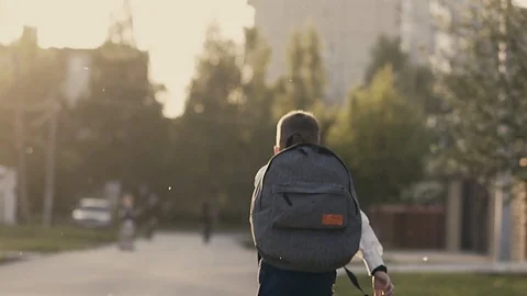 CU, Tracking, Slow motion, Back view shot: Student after school hours runnning Video stock 105145126