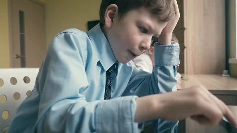 CU, Tracking, Slow motion: Pupil works on a tablet computer, does lessons Video stock 105099625