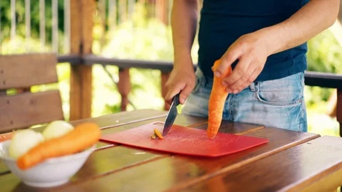CU, Travelling shot: Young guy is standing in summer house, cooking pilaf, for Stock-Footage 104509660