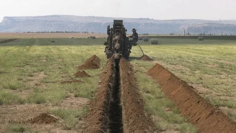 CU of trench, tilt up to Trench Digger Video stock 80456465