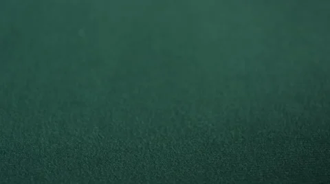 CU of two stacks of chips being placed down on green felt table Stock Footage 53240582