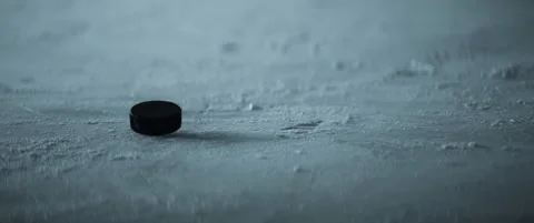 CU View of a hockey puck falling on ice in slow motion Video stock 166674481