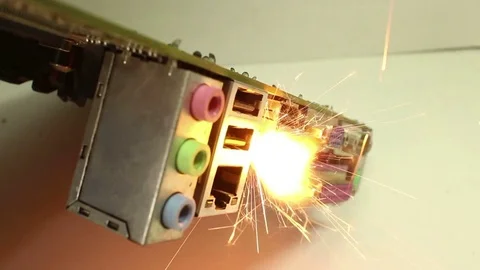 CU view of sparks and burning computer: audio jacks Stock Footage 76453054