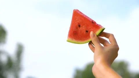 CU of watermelon slice with female hand Woman showing ripe watermelon. Stock Footage 158886470