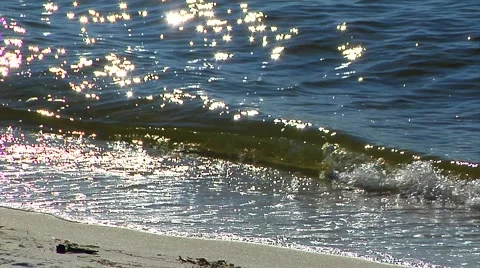 CU Waves breaking, on beach, sparkling and back-lit. Florida Stock-Footage 57703300