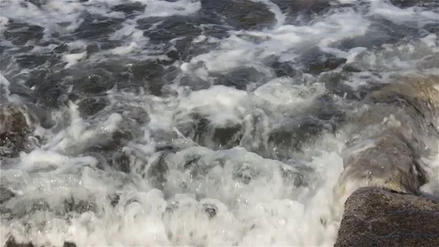 CU - waves rolling over sunken walls of ancient harbor Stock Footage 82260859