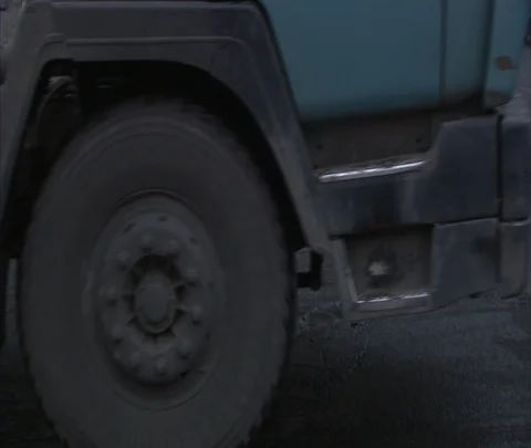 CU wheels of passing coal truck Stock Footage 86744843